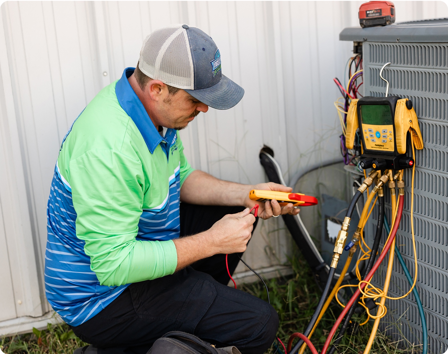 Technician performing AC maintenance